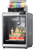 3D printer with colorful filament spools and a printed castle model inside the printer bed.