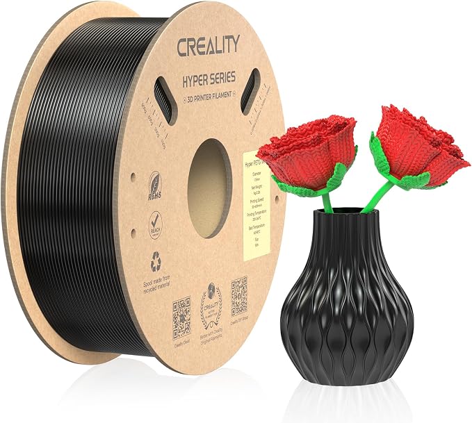 Creality Hyper PETG filament spool beside a black textured vase holding two red knitted roses.