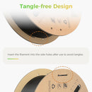 Product feature graphic for a spool of black filament, showing two views of the spool with text reading 'Tangle-free Design' and instructions to insert the filament into the side holes after use.