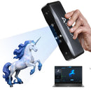 Hand holding a device projecting a unicorn onto a screen with a unicorn figurine on a white background