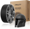 Creality 3D printer filament spool with a helmet made from the material in front of a Creality branded box.