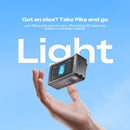 A hand holding a small black Pika camera against a bright blue sky background, with large white text reading 'Light' and smaller promotional text above.