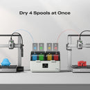 3D printer with spool holder and 'Dry 4 Spools at Once' text on a gray background
