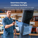 A man in a workshop uses a handheld laser scanner to measure a tall dark surface. Large text at the top reads 'Seamless Range, Limitless Surface,' and blue measurement overlays show dimensions of the scanned surface.