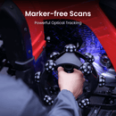 A hand holding a black circular tracking device with multiple spherical sensors, shown in a red and blue vehicle interior. White text at the top reads 'Marker-free Scans' and 'Powerful Optical Tracking'.