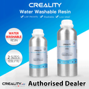 A promotional graphic for Creality Water Washable Resin displaying both the 0.5L (500g) and 1L (1000g) silver bottles against a vibrant blue and white background. The image highlights three core product advantages with checkmarks: Low viscosity, Washable, and Low smell. Circular badges on the left reiterate the 'Water Washable Resin' formulation and the '2 SIZES: 0.5L / 1L' availability. The bottom prominently features a 'Creality AU Authorised Dealer' logo to establish local Australian consumer trust